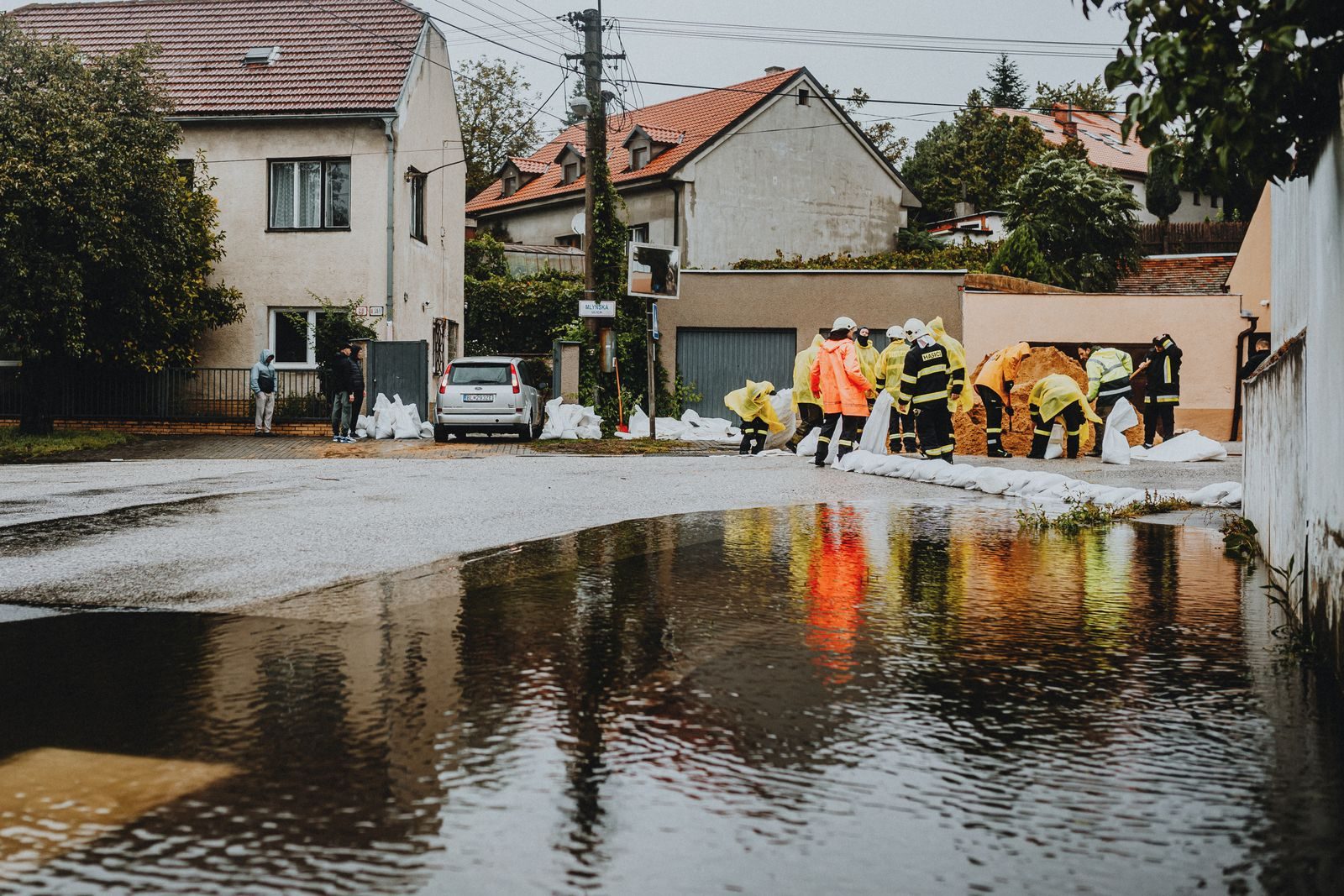 Emergency responders working a flooded street during a storm